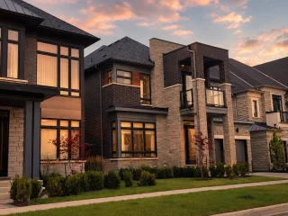 Detached homes along a residential street at sunset